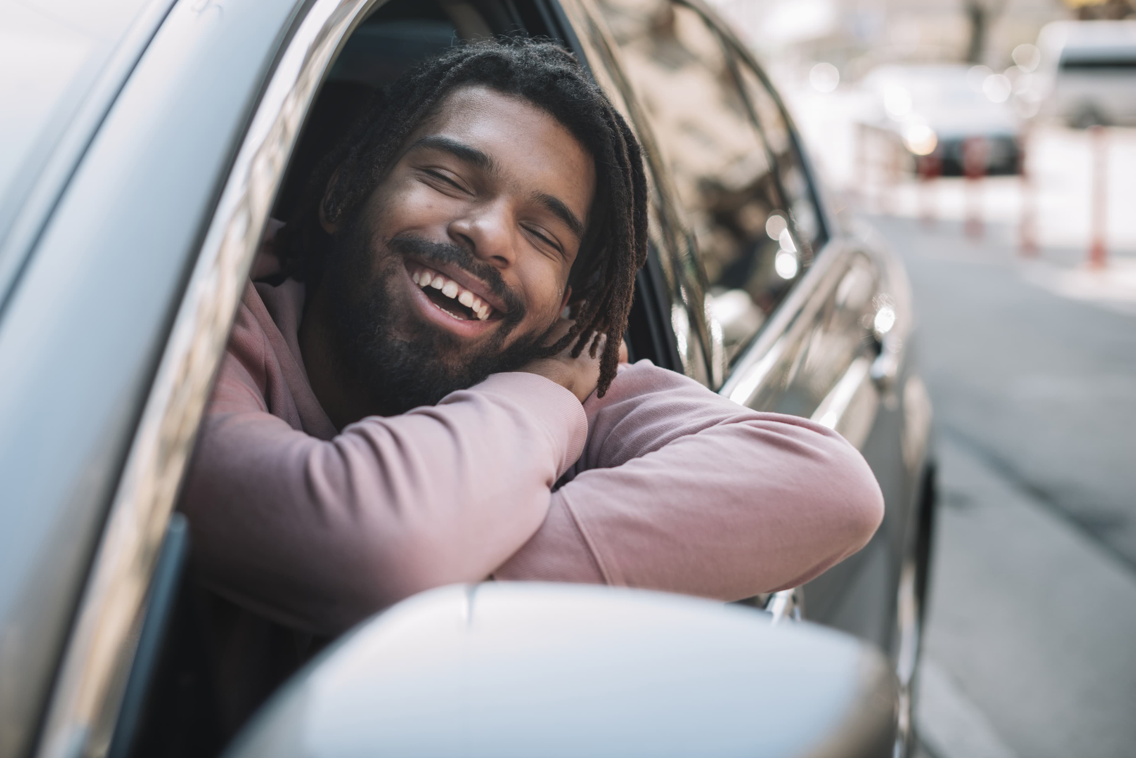Homme souriant avec sa voiture
